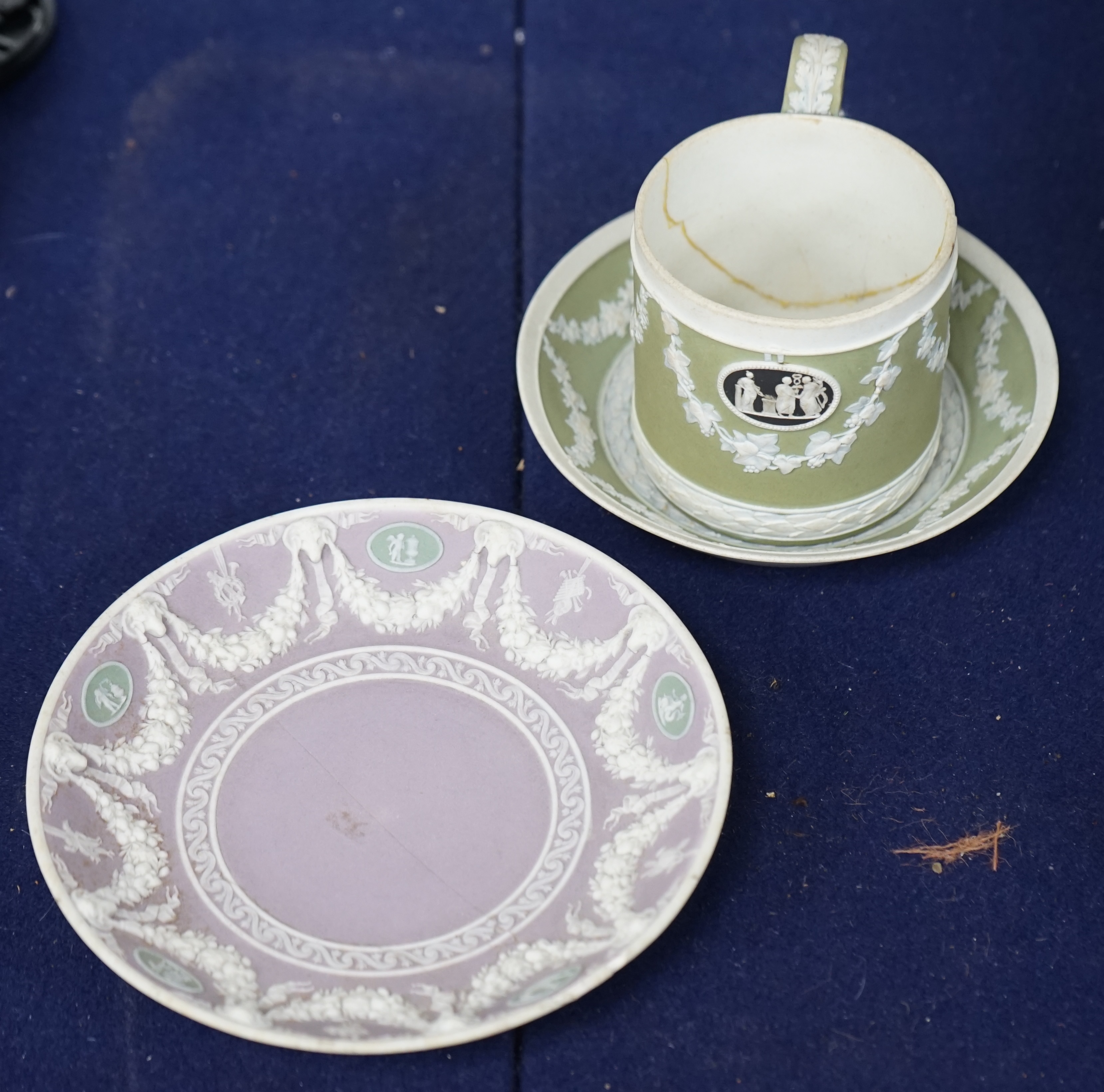 A Wedgwood three colour, green ground jasper cup and saucer and a single lilac ground saucer, early 19th century, 13.5cm. Condition - poor